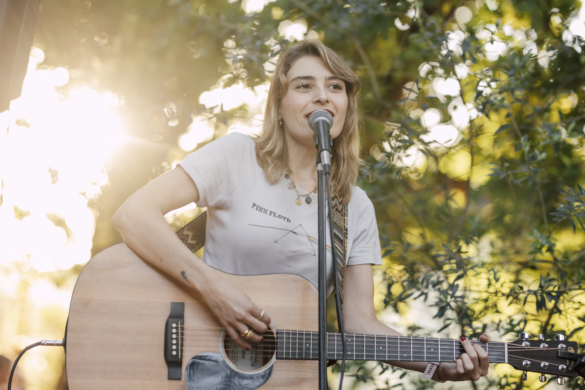 Singer playing guitar in golden afternoon light