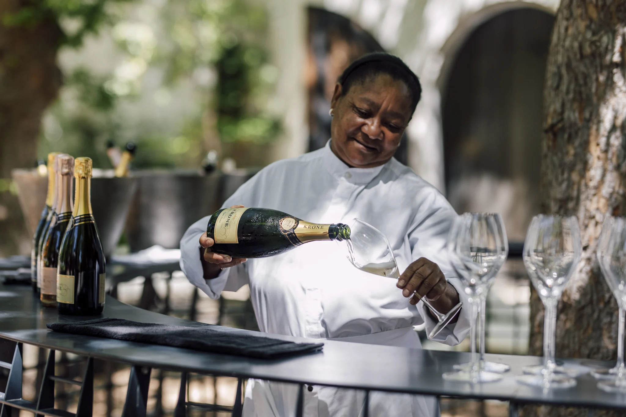 Wine being poured beneath the trees at De Stilte