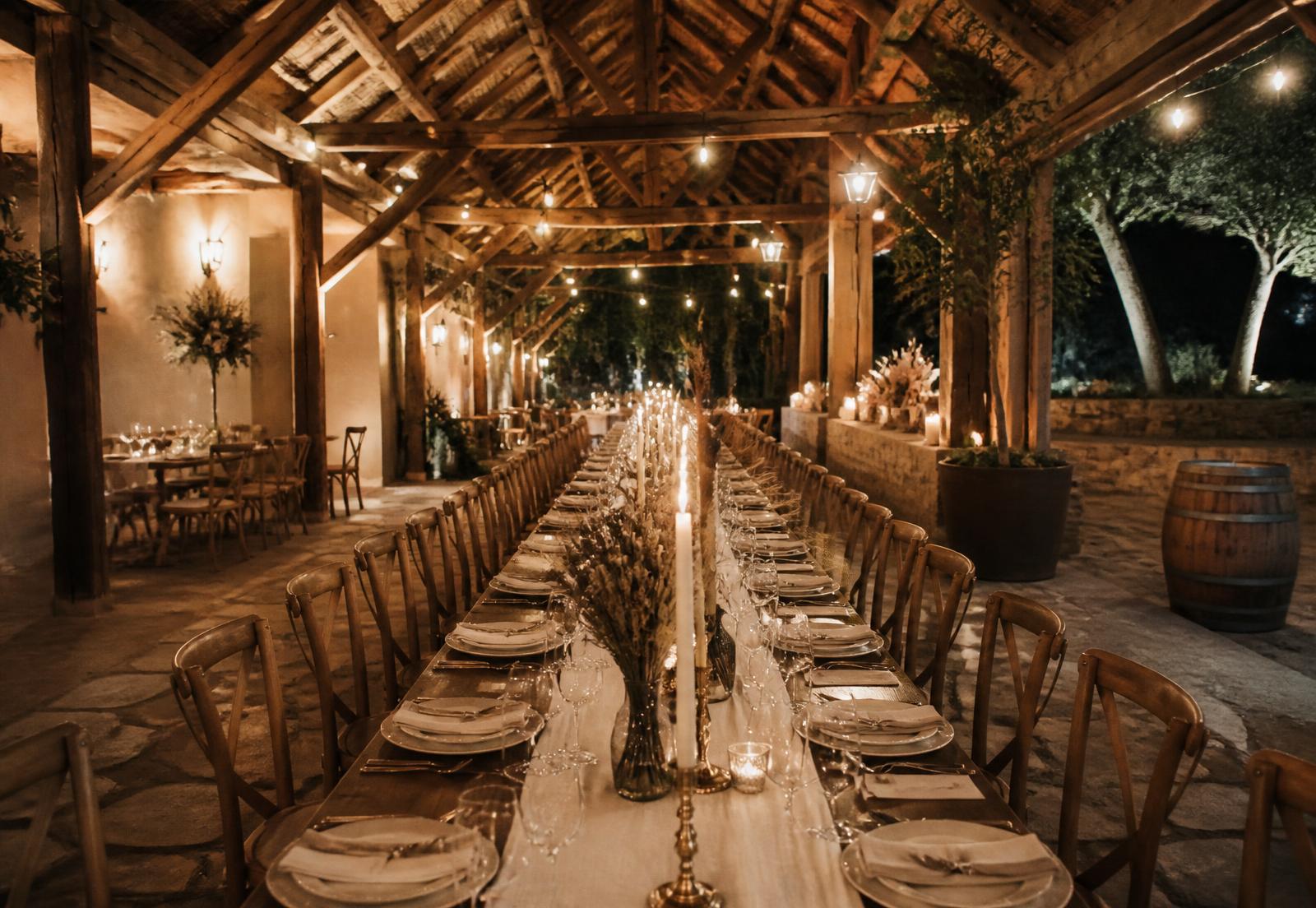 Long reception table set under the timber beams of the Oak Shed